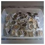 STORAGE TUB FILLED WITH HUNDREDS OF METAL STUDENT OF THE MONTH MEDALLIONS
