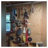 ALL ITEMS HANGING IN SHOP WALL AREA TO THE RIGHT OF WINDOW AND TO THE LEFT OF MARKING TAPE INCLUDING C-CLAMPS, HACKSAWS, CLAMPS, 1/4 INCH METAL BARS, AND MORE
