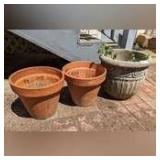TERRACOTTA AND CAST STONE PLANTERS BEHIND HOUSE