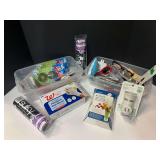 Assorted household goods to include Airwick mist fragrance replacement, and plug-in, powdered vinyl gloves, shower curtain hooks, clear floral setting resin, and more. Tubs are not included, see pictu