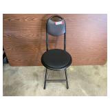 Black padded portable folding chair, see pictures for details.