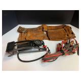 Leather tool pouches with belt, small jumper cables, and foot pump. See pictures for details.