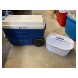 Coleman wheeled cooler, lid hinges are broken, however, cooler can still be used. Also includes a Sterilite storage carrying tray, see pictures for details.
