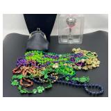 Assorted Mardi Gras style beads, Jordache coin purse, and a Hallmark baby’s first Christmas ornament, see pictures for details.