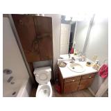 Bath… Bathroom lot marked 1542, includes all content of hallway bath to include assorted towels, home decor, wooden over the toilet storage shelf with content, and more. See pictures for details.