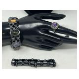 Ladies stretch bracelets, includes one with oval multicolored stones, a magnetic hematite bracelet, and a ladies fashion cocktail ring with a faceted amethyst colored stone surrounded by small green s