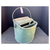 Vintage metal mop bucket with wooden rollers, see pictures for details.