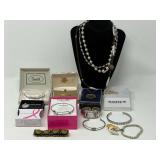 Round wooden storage/pantry box filled with assorted lady fashion estate jewelry to include necklaces, cuffed bracelet, cuff watch, brooch, and more. See pictures for details. ￼