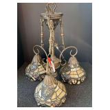 Three light, hanging swag light. Shades have a stained glass look, see pictures for details.