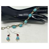 Ladies silver bracelet and earrings, stones resemble Larimar, both are stamped 925, earrings also contain ruby colored stones, see pictures for details.