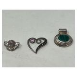 Ladies silver pendants, both pieces are stamped 925, includes an open heart pendant with a pink stone that resembles pink sapphire, also includes an oval pendant with a stone that is believed to be ma