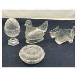 DEN… Vintage glass trinket dish with floral motif, footed egg shaped trinket dish, believed to be vintage Avon, clear glass hen on a nest, believed to be vintage candy container from JH Milstein, an