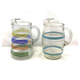 KIT… Vintage glass pitchers to include MCM) Orbit Stripe glass pitcher with blue and gold rings, and one with with a rainbow stripe design, believed to be vintage Anchor Hocking, see pictures for de