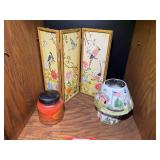 BR3…Shelf lot marked 1580 of assorted home decor to include a porcelain candle lamp, large candle, and decorative four panel table decor, see pictures for details.