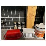 KIT… Assorted kitchen items to include a butter dish, jaccard, Oxo ￼ salt and pepper grinders, Blazing Bella balsamic vinegar with wooden storage box, and more. See pictures for details.