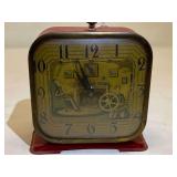 LR…Vintage Lux Clock Manufacturing Co. animated "Spinning Wheel" wind-up alarm clock. It is a mechanical 30-hour alarm clock. 
The clock face has an art deco-style lithograph. See pictures for detai