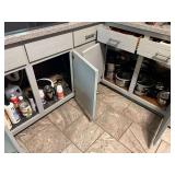 KIT… Cabinet lot marked 1179, includes all content from lower cabinets and drawers from edge of stove to edge of dishwasher. Items include cutlery, pots and pans, some cleaning supplies, and more. S