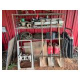Metal rack with content to include shovels, hose reel, hoses, plastic sawhorses, small tile and more