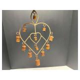 Metal heart shaped wind chimes with bells, rust is present, see pictures for details.