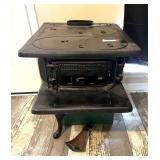 LR… Vintage/antique, small cast-iron Dixie Belle wood cook stove, includes a vintage cooler, the front leg needs to be reattached, is included, see pictures for details.