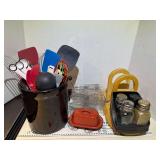 Assorted kitchen items to include utensil holder with utensils, butter dish, spoon rest, napkin holders, and more. See pictures for details.