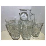 Italian clear glass pitcher with four vintage footed iced tea glasses, believed to be vintage Indiana glass, Whitehall pattern, five pieces total, see pictures for details.