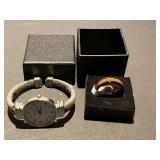 DR… Men’s black band with wood inlay ring, size 13, also includes a ladies Details bangle watch, see pictures for details.