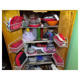 KIT… Pantry lot marked 1080, includes all content of pantry cabinets. Some items include a coffee mug tree, shelf organizer, large assortment of storage containers, paper plates, and more. See pictu