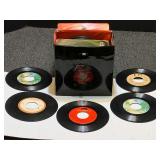 Assorted vintage 45’s with storage container, see pictures for details.