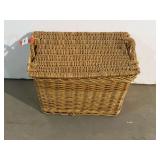 Large lidded rattan storage basket with handles.