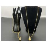 Vintage Joan Rivers gold-tone egg pendant necklace featuring faux seed pearls and a vintage Joan Rivers gold-tone egg pendant necklace with a clear lucite or crystal cabochon and a braided rope and bo