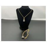 Vintage Joan Rivers black caviar crystal pavé egg pendant necklace with a gold-tone chain. Also includes a vintage Joan Rivers gold-tone, enamel, and crystal ladybug egg pendant necklace. See picture