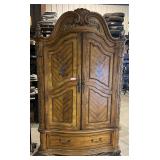 Venetian style two piece armoire, has double door top with storage shelves and drawers, and one drawer bottom piece. Top right door clips need adjusting or replacing, door sometimes drifts open. See p