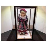 Collectible doll with doll case, front case plastic is cracked, see pictures for details.