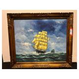 Framed nautical oil painting of a clipper ship on rough seas.