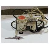 Small airbrush compressor with hose and tip, powers up, see pictures for details.