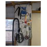 ALL ITEMS HANGING IN WALL AREA MARKED 9160 INCLUDING GREASE GUN, WASHING MACHINE HOSE, THERMOMETER, TOOLS, AND MORE