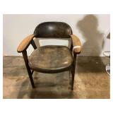 Wood framed mid-century modern barrel-back armchair with a vinyl seat and backrest, see pictures for details.