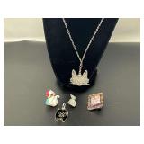 Vintage cat brooches and pendants, includes a vintage REO silver-tone enameled picture frame and laying cat brooch, see pictures for details.