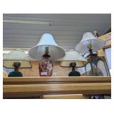 FOUR VINTAGE DECORATIVE LAMPS ON TOP OF CABINET