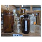 ANTIQUE BOTTLES IN SHELF SECTION MARKED 1674