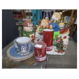 SLEDDING SNOWMEN COOKIE JAR, SNOWMAN MOTIF CANDLE LANTERN, CHRISTMAS PLATES, AND MORE IN SHELF SECTION MARKED 1689