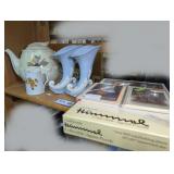 DECORATIVE TEAPOT, CORNUCOPIA VASES, AND HUMMEL ACCESSORIES ON SHELF MARKED 1670
