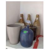 ANTIQUE GLAZED POTTERY BEER BOTTLES AND OTHER POTTERY IN SHELF AREA MARKED 1105