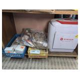 VINTAGE CLOTH DOLLS, SINGER SEW ESSENTIALS CASE, CIGAR BOX FULL OF PATCHES, AND FLORIST PINS ON BOTTOM SHELF MARKED 1483