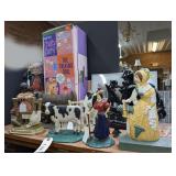 8 VINTAGE CAST IRON DOOR STOPS AND MORE ON TOP OF CABINET MARKED 1477B