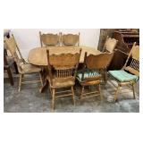 Double pedestal dining table with extra leaf, includes six pressed back spindle chairs, some of the chairs may need repair, see pictures for details.