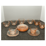 Assortment of pink depression glass, to include cups, plates, and creamer. Approximately 15+ pieces, see pictures for details.