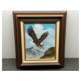 Vintage oil painting on canvas by  artist W. Amadio, depicting a bald eagle soaring in a mountainous landscape. See pictures for details.