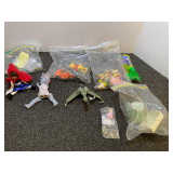 Assorted  children’s small toys to include a Madame Alexander doll, collectible Pez dispenser, and more. Tub is not included, see pictures for details.